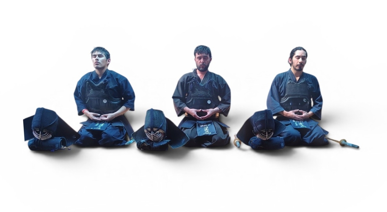 Kendoka performing zarei (seated bow) in the dojo — reiho before practice